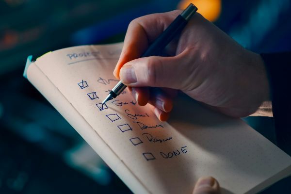 Hand ticking off items on a checklist